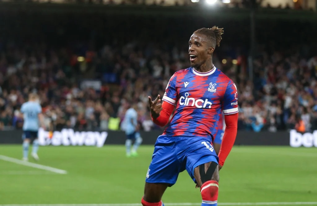 crystal-palaces-wilfried-zaha-celebrates-756821900-e1661895095406